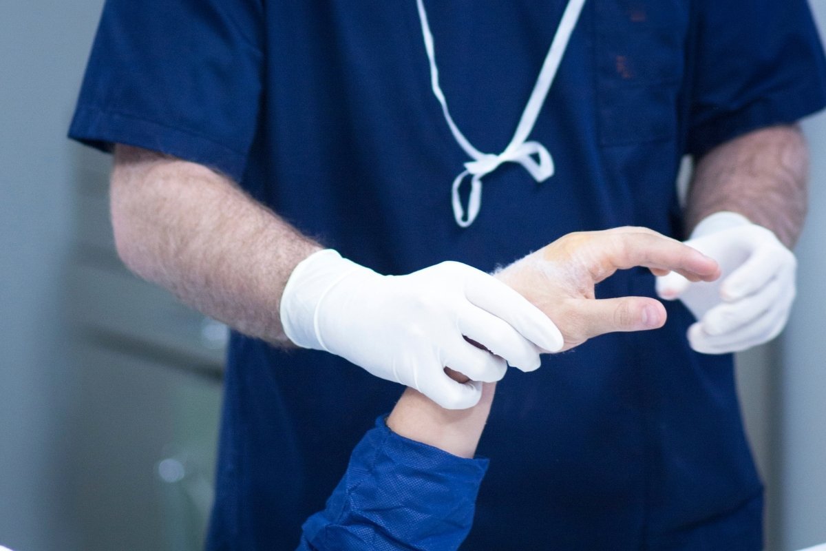 Surgeon examining a patient&rsquo;s hand before hand surgery at Sama Hospital, South Delhi