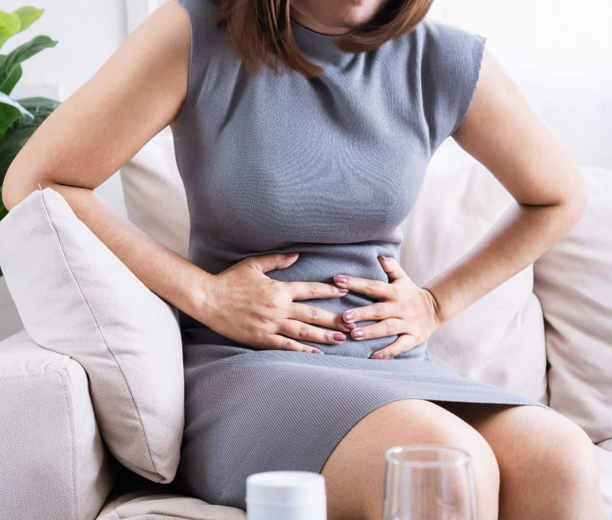 Person experiencing abdominal discomfort and bloating from irritable bowel syndrome